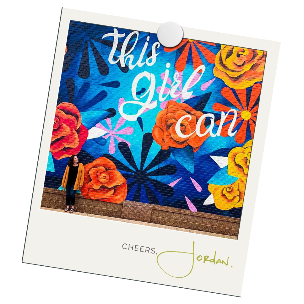 Work With Me Polaroid of Jordan standing against a colorful mural that reads "This Girl Can"