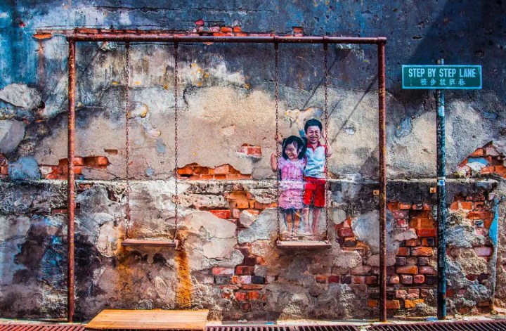 "Siblings On A Swing" mural in Malaysia
